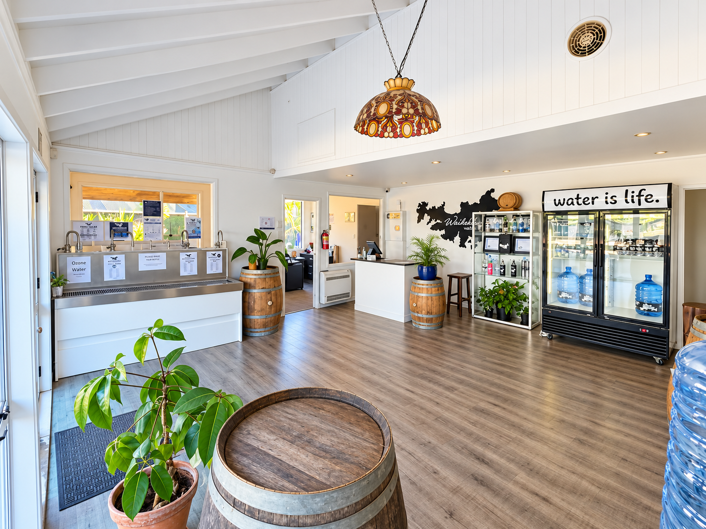 Inside the Waiheke Water shop at Tahi Road, with refill taps, display cabinet and bottled water